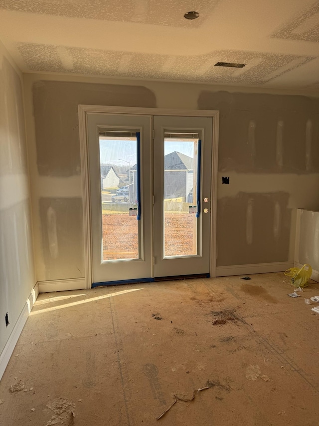 doorway featuring a textured ceiling