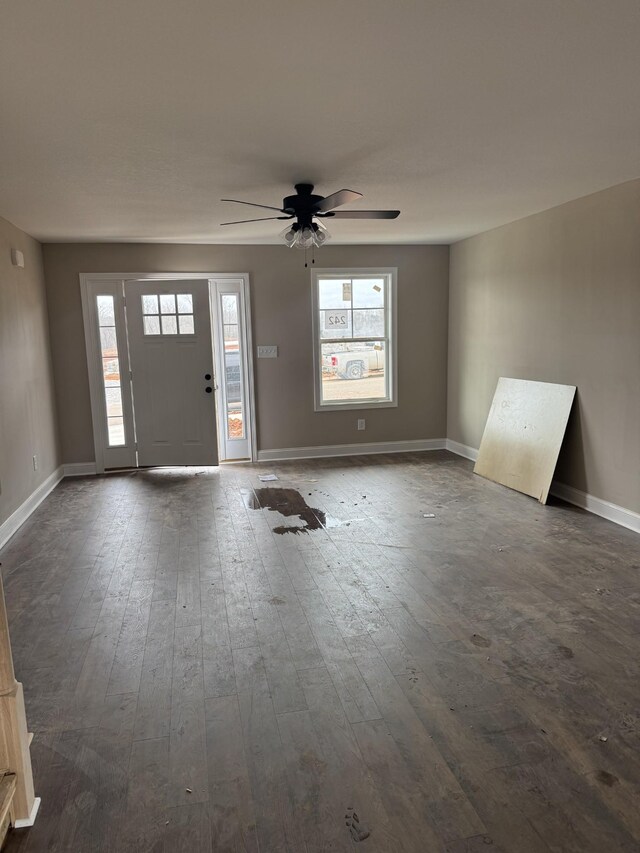 foyer entrance featuring baseboards, dark wood finished floors, and a ceiling fan