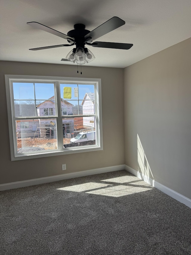 unfurnished room with carpet flooring and baseboards