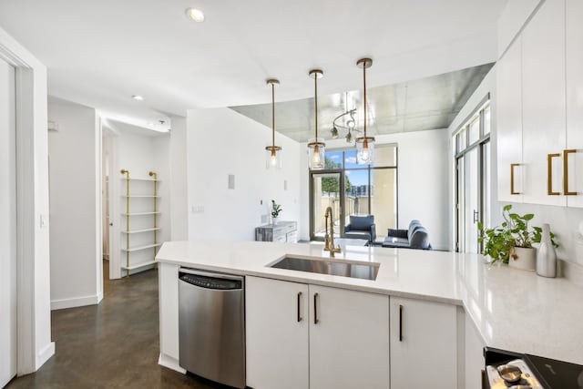 kitchen with kitchen peninsula, sink, decorative light fixtures, stainless steel dishwasher, and white cabinets