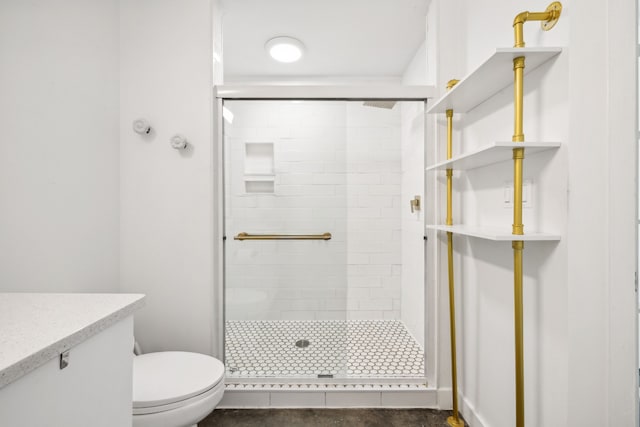 bathroom with vanity, a shower with shower door, and toilet