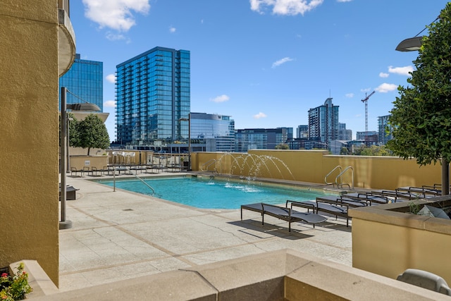 view of swimming pool featuring a patio area and pool water feature