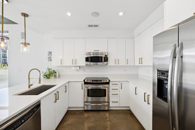 kitchen with appliances with stainless steel finishes, sink, and white cabinets