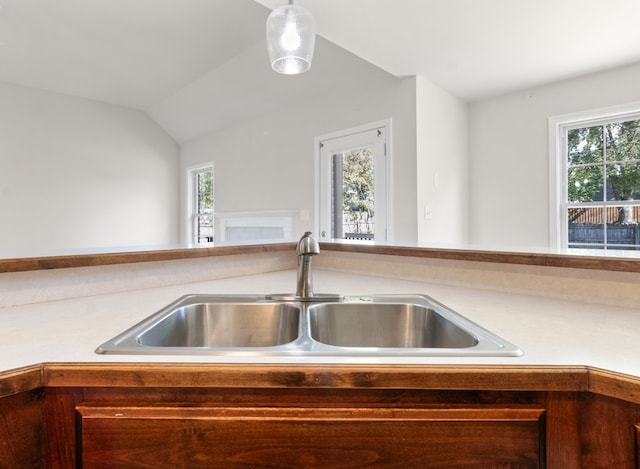 kitchen with sink and lofted ceiling