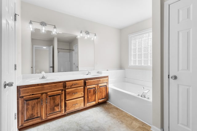 bathroom with vanity and shower with separate bathtub