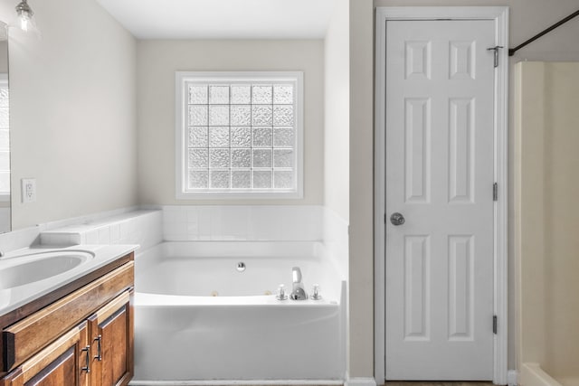 bathroom featuring a washtub and vanity