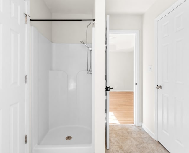 bathroom with hardwood / wood-style floors and walk in shower