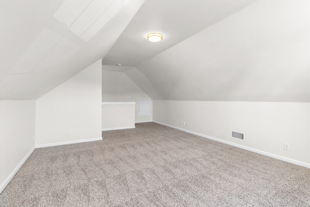 bonus room with carpet and lofted ceiling