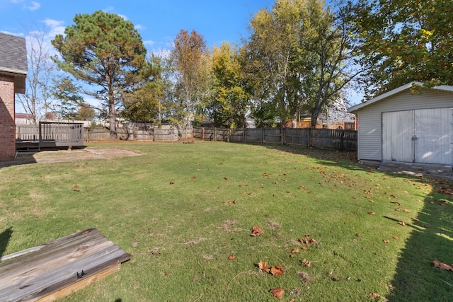 view of yard with a shed and a deck