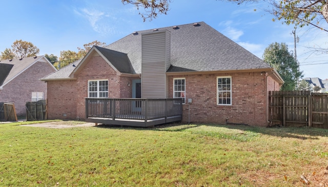 rear view of house with a deck and a lawn