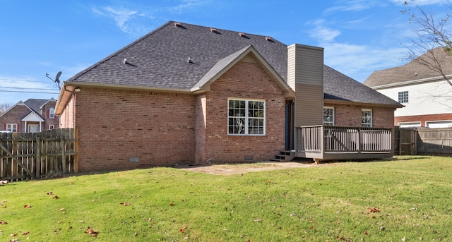 rear view of house with a yard and a deck