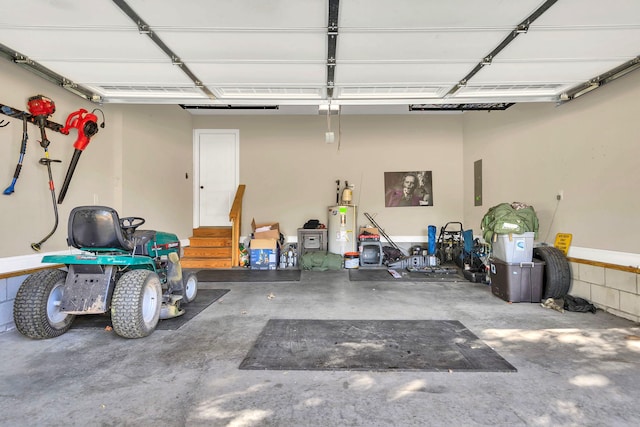 garage featuring electric panel and water heater