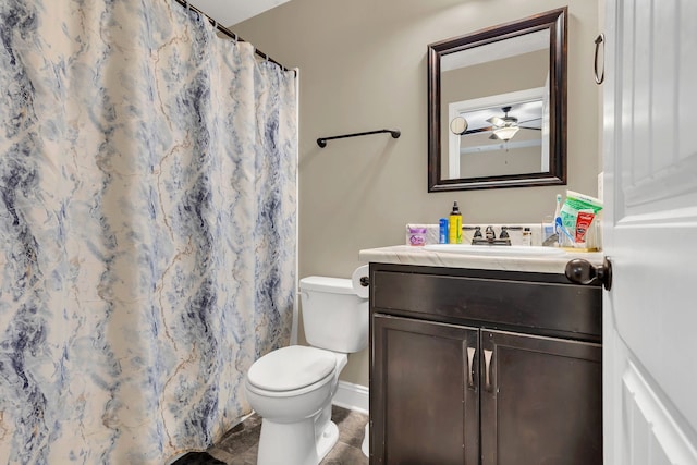 bathroom featuring toilet, tile patterned flooring, vanity, ceiling fan, and walk in shower