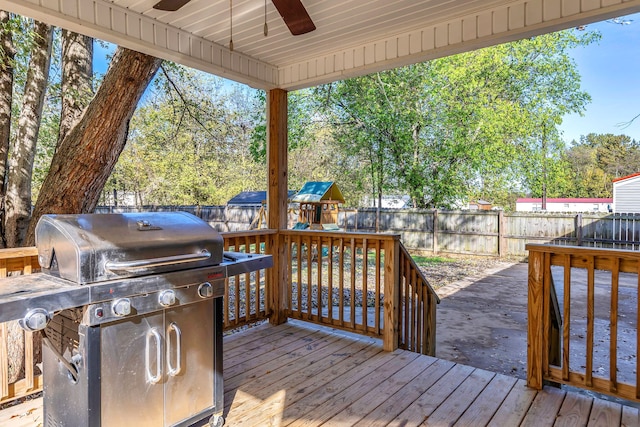 wooden terrace with area for grilling and a playground