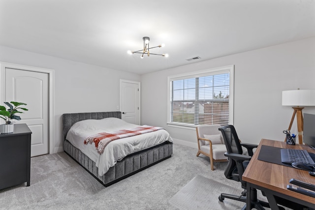 carpeted bedroom featuring a chandelier