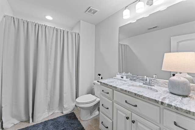 bathroom featuring toilet, walk in shower, vanity, and tile patterned flooring