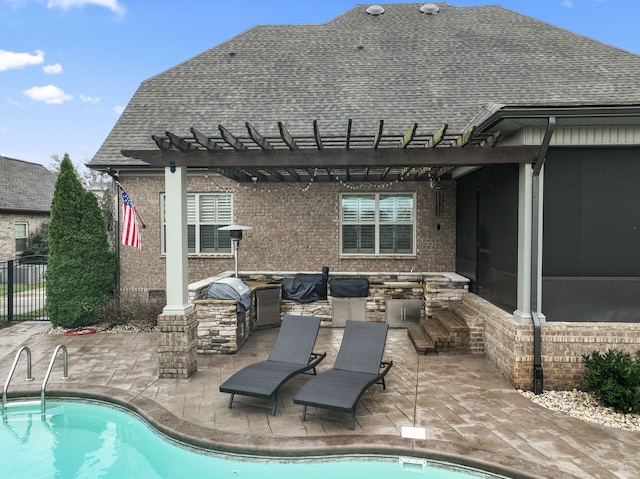 rear view of house featuring a patio, a fenced in pool, an outdoor kitchen, and a pergola