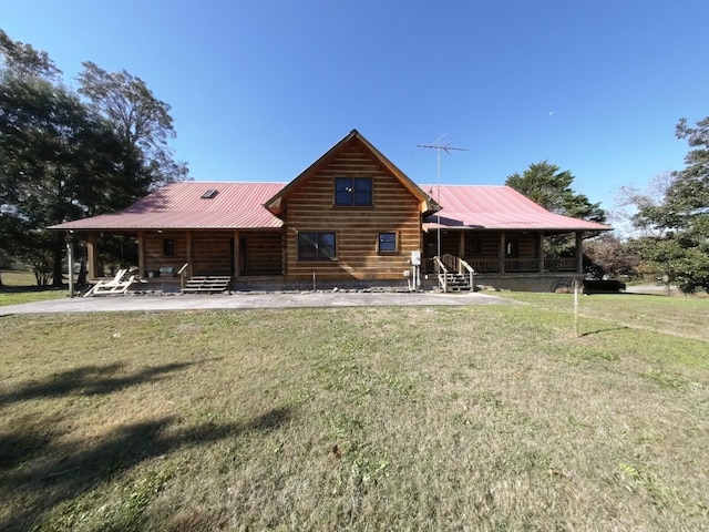 rear view of property featuring a yard and a patio area