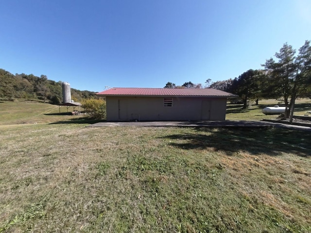 view of side of home with a lawn