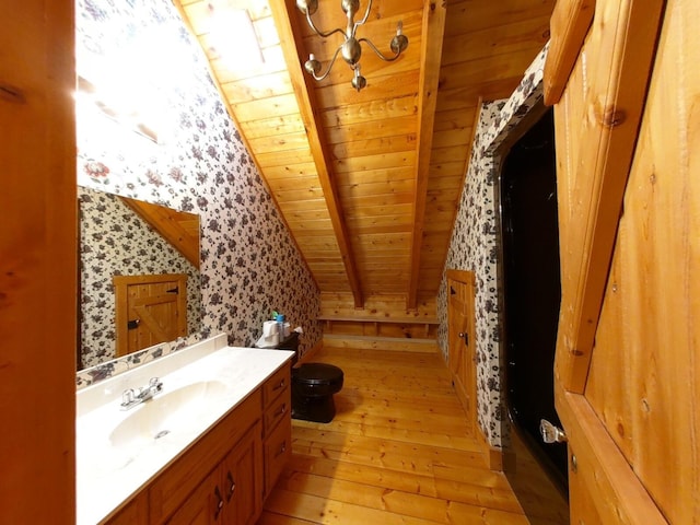 bathroom featuring vaulted ceiling with beams, wood ceiling, hardwood / wood-style flooring, toilet, and vanity