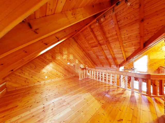 bonus room with wood ceiling, ceiling fan, wood-type flooring, wood walls, and lofted ceiling with beams