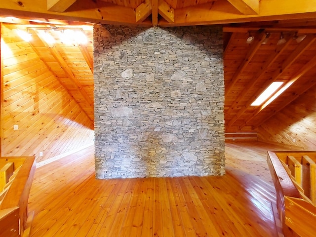 bonus room with wood ceiling, wood walls, hardwood / wood-style floors, and lofted ceiling