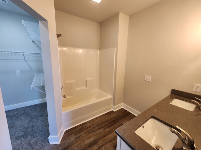 bathroom featuring vanity, hardwood / wood-style flooring, and shower / tub combination