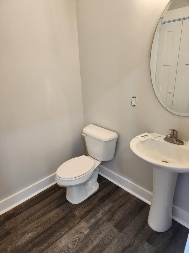 bathroom with hardwood / wood-style floors and toilet