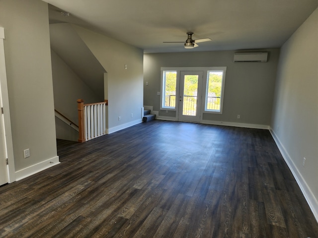 interior space featuring a wall unit AC, dark hardwood / wood-style floors, and ceiling fan