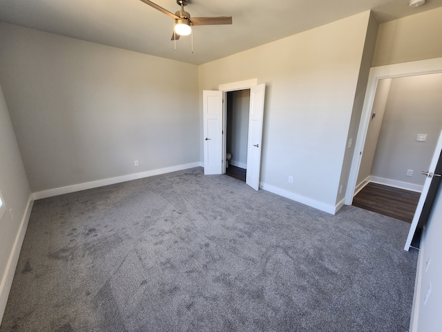 unfurnished bedroom with dark carpet and ceiling fan