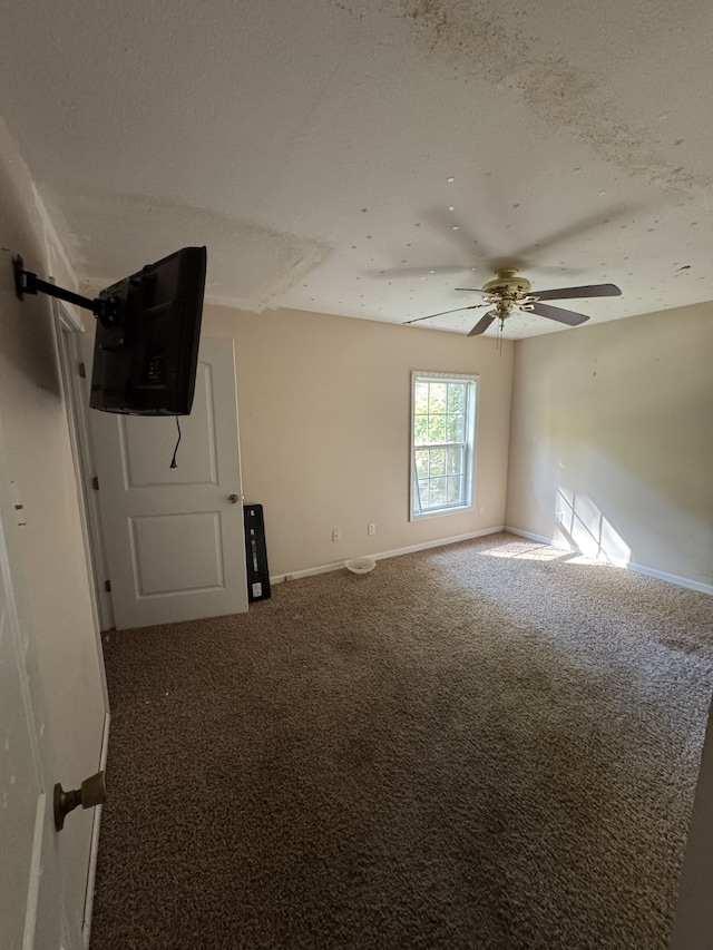 spare room with carpet, a textured ceiling, and ceiling fan