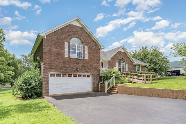 view of property featuring a front lawn and a garage