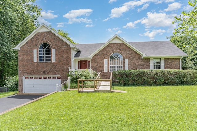 view of front of property with a front yard and a garage