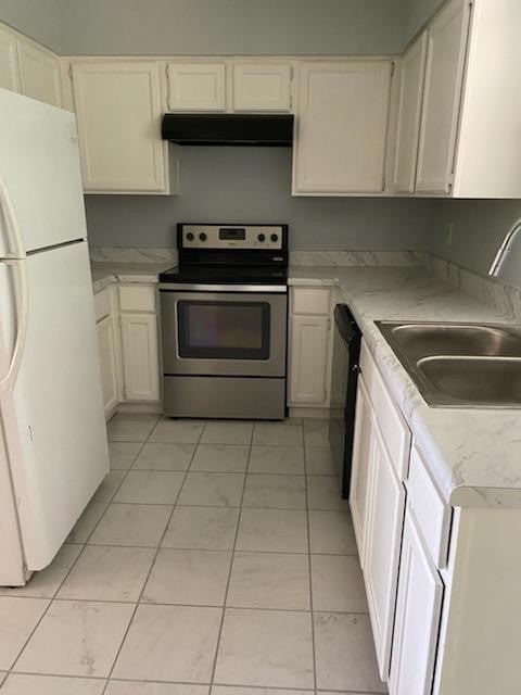 kitchen featuring white cabinetry, white fridge, sink, and stainless steel electric range oven