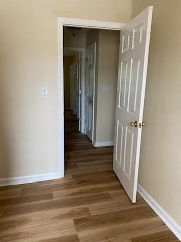 corridor featuring hardwood / wood-style floors