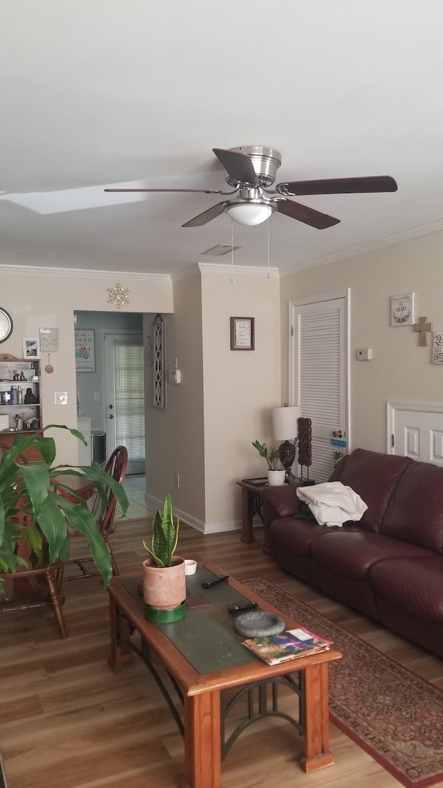 living room with crown molding, hardwood / wood-style flooring, and ceiling fan