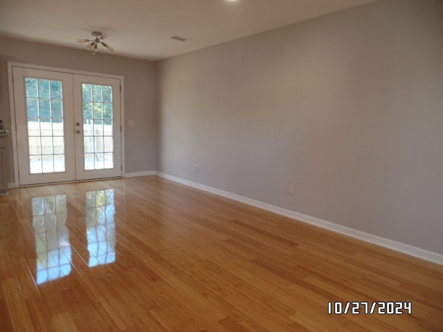 unfurnished room with light hardwood / wood-style flooring and french doors