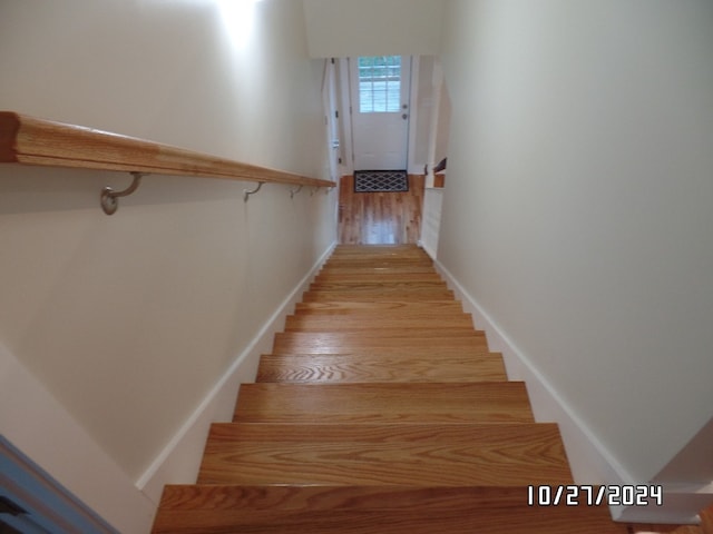 staircase featuring wood-type flooring