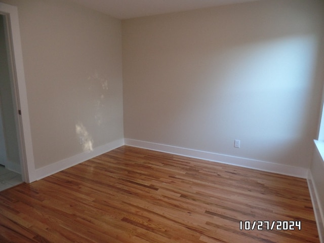 empty room with light hardwood / wood-style flooring