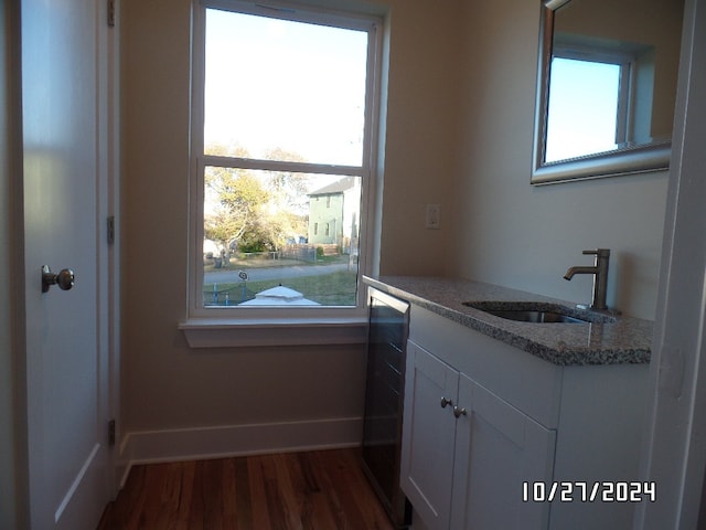 bathroom featuring a wealth of natural light, vanity, and hardwood / wood-style floors