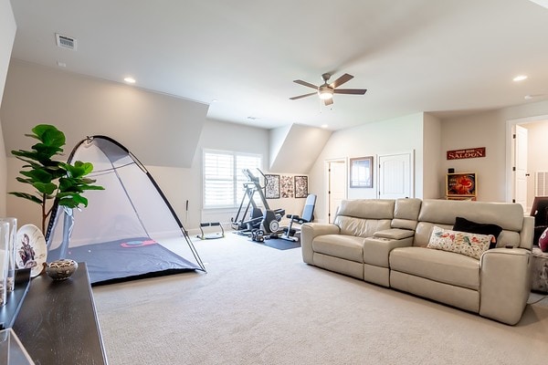 carpeted living room featuring ceiling fan