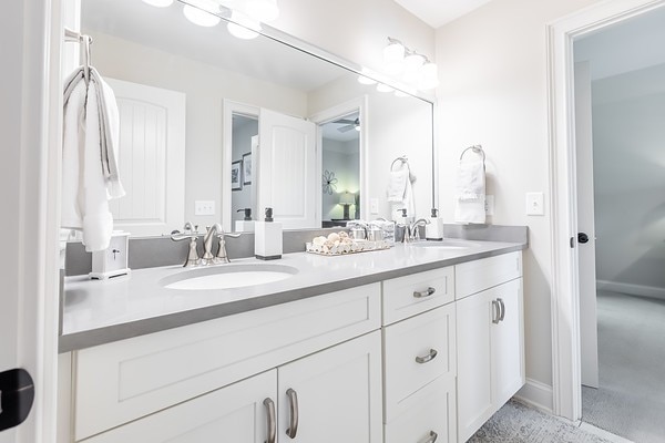 bathroom featuring ceiling fan and vanity