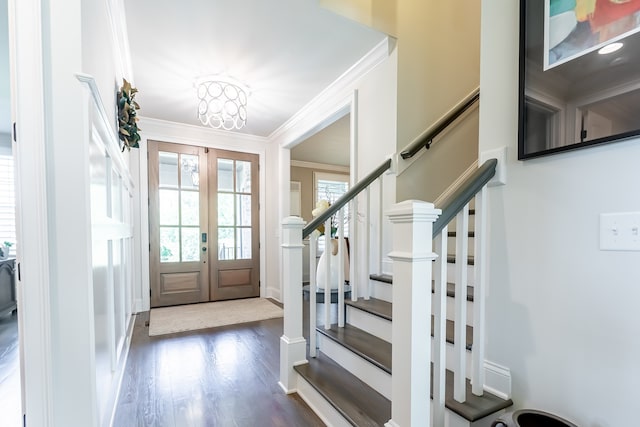 entryway featuring french doors, dark hardwood / wood-style floors, and crown molding