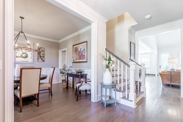 interior space featuring crown molding, a notable chandelier, and hardwood / wood-style flooring