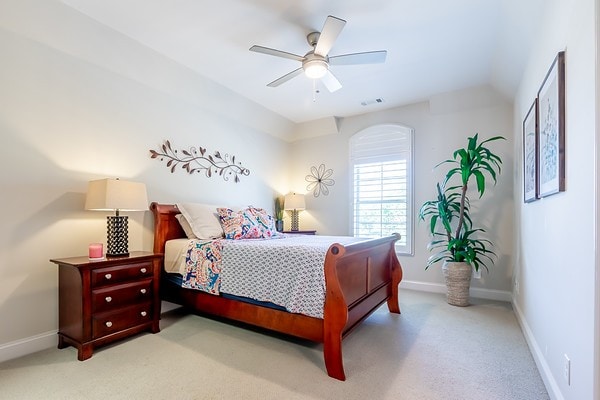 bedroom featuring light carpet and ceiling fan