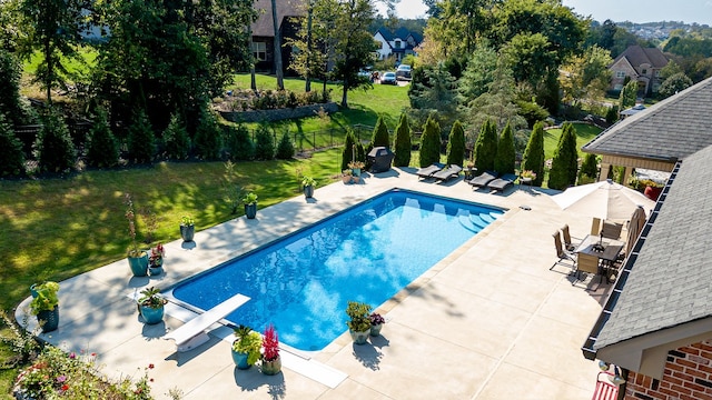 view of pool featuring a lawn, a diving board, and a patio