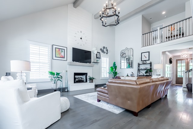 living room with a fireplace, dark hardwood / wood-style floors, high vaulted ceiling, and plenty of natural light