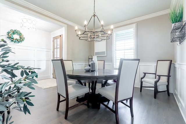 dining area with an inviting chandelier, dark wood-type flooring, and ornamental molding