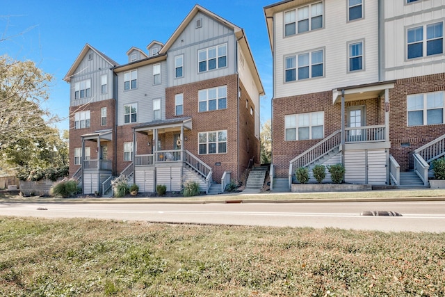 multi unit property featuring a front yard and a porch