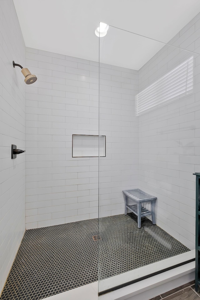 bathroom featuring a shower with door